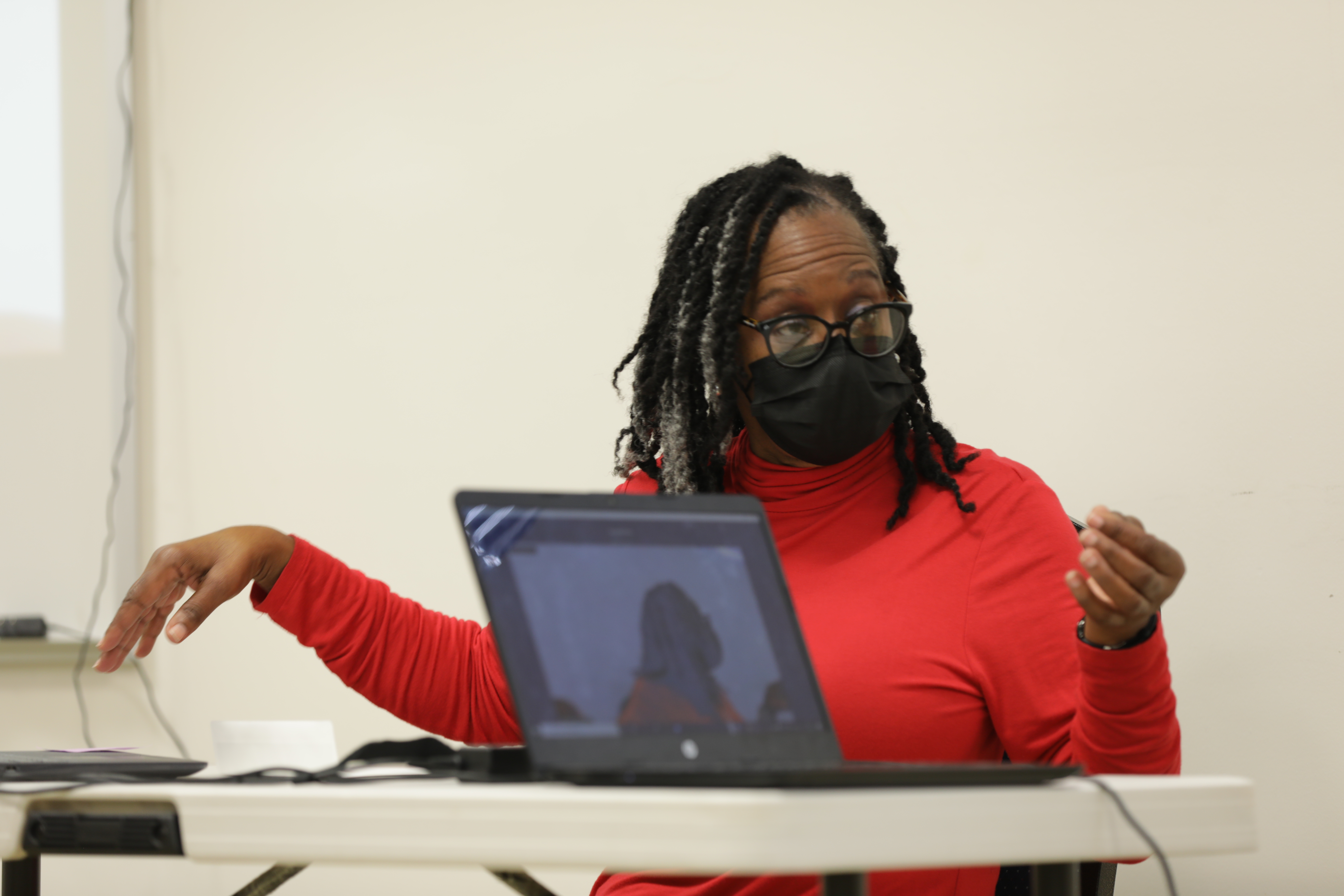 Woman in mask at laptop