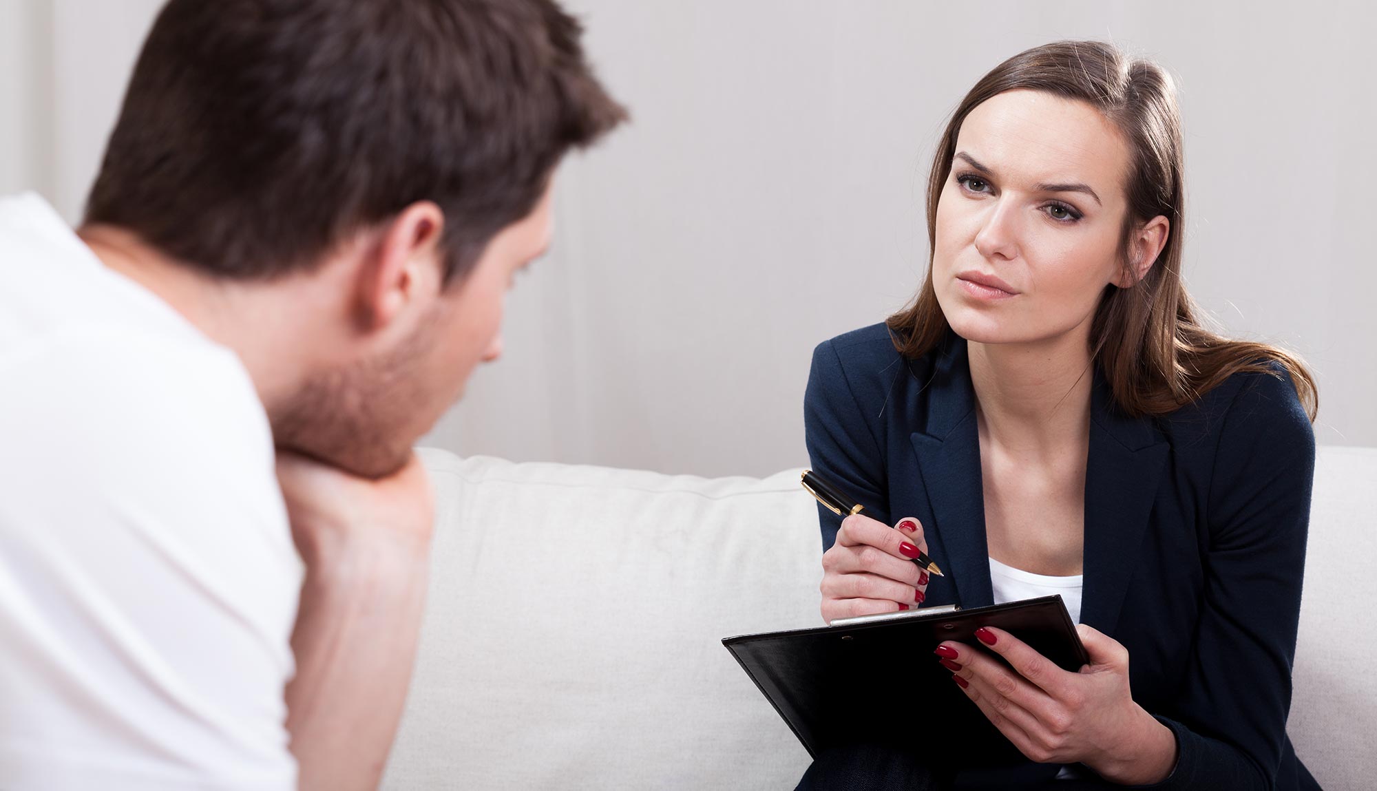 A clinical psychologist talks with a patient.