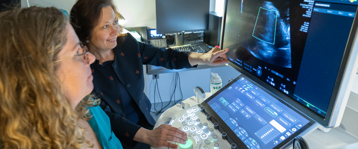 Dr. Sinkovskaya pointing at an ultrasound machine