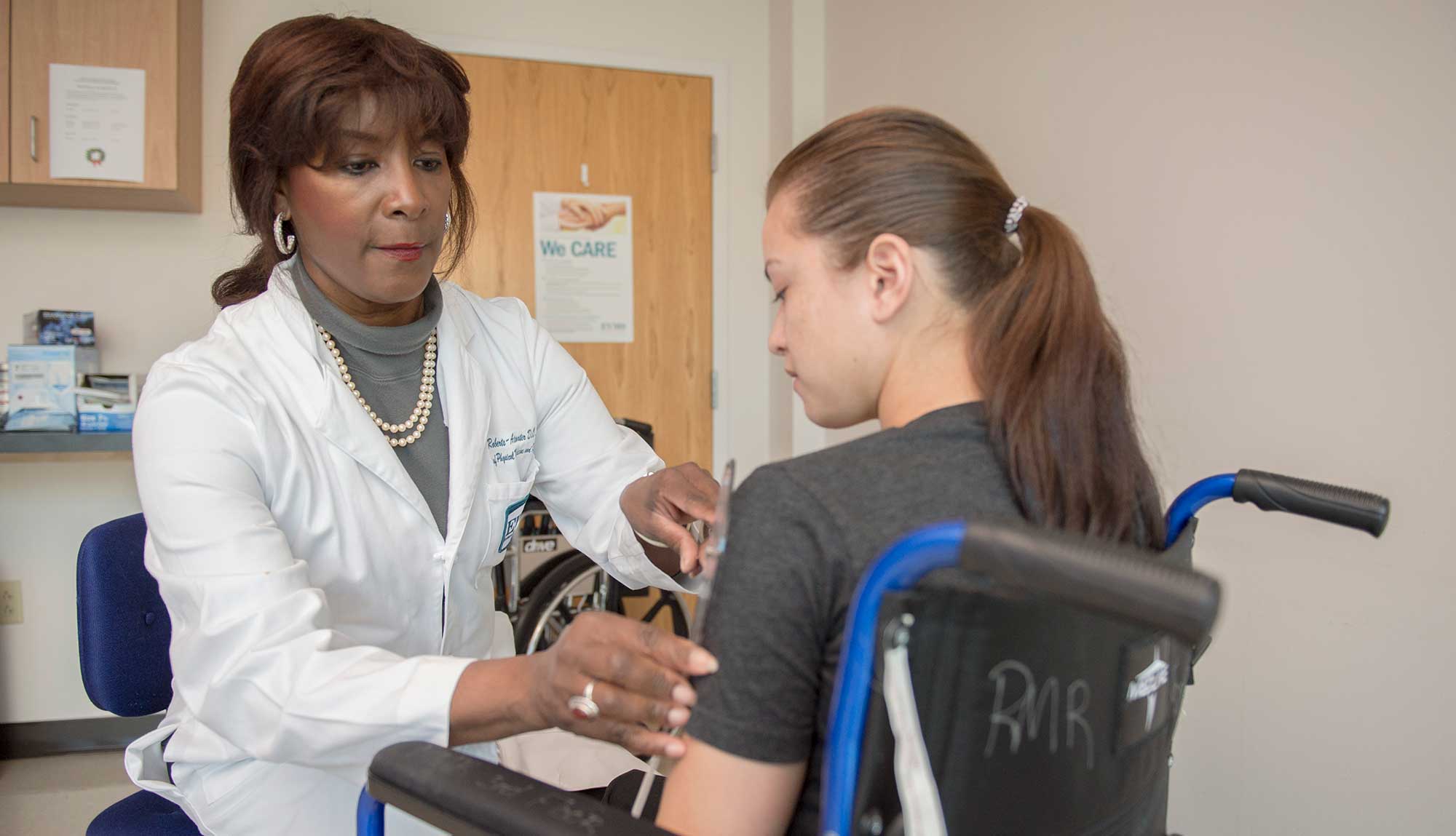 Dr. Beverly Roberts-Atwater examines a patient.