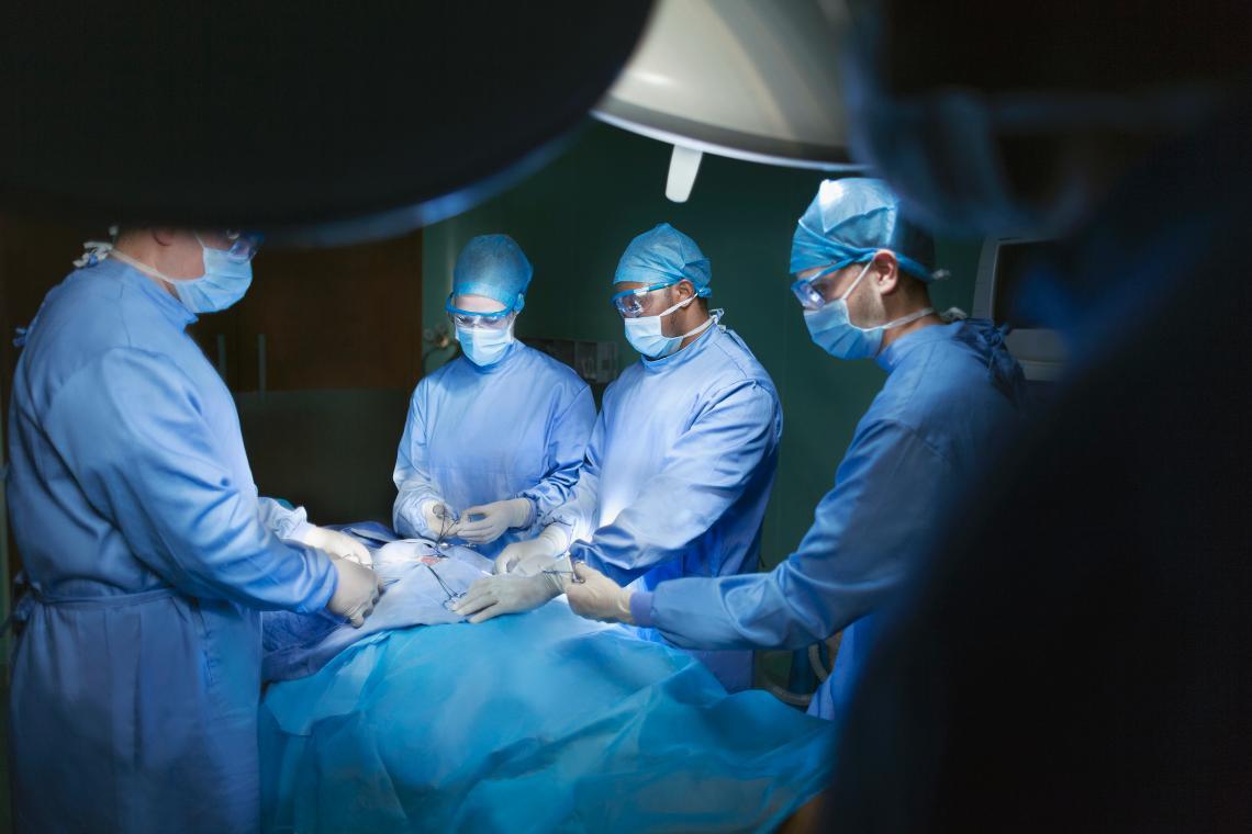 Image of surgeons performing a procedure in an operating room.