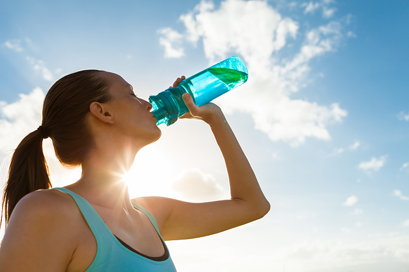 woman drinking water in the sun