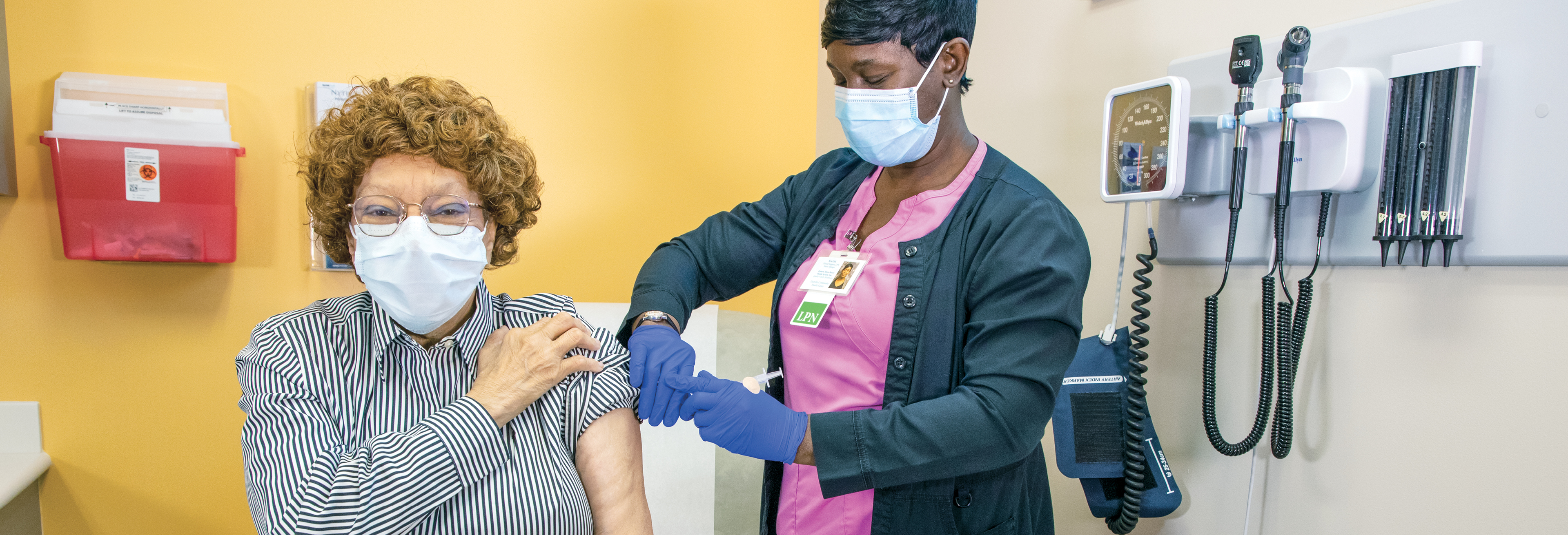 A nurse with the Eastville Community Health Center administers a COVID-19 vaccination to Betty B. Bibbins, MD ('MD 82).