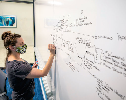 Physician assistant student Rebecca Rush draws on a white board in a first-floor study room at Waitzer Hall in preparation for a test.