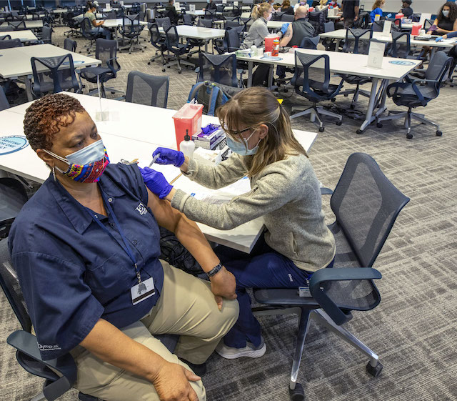 An EVMS employee receiving a vaccination