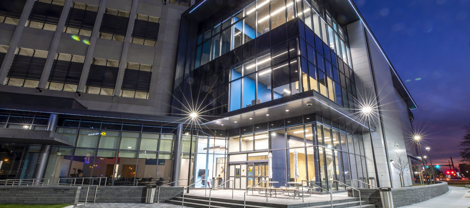 A closer view of Waitzer Hall entrances at night