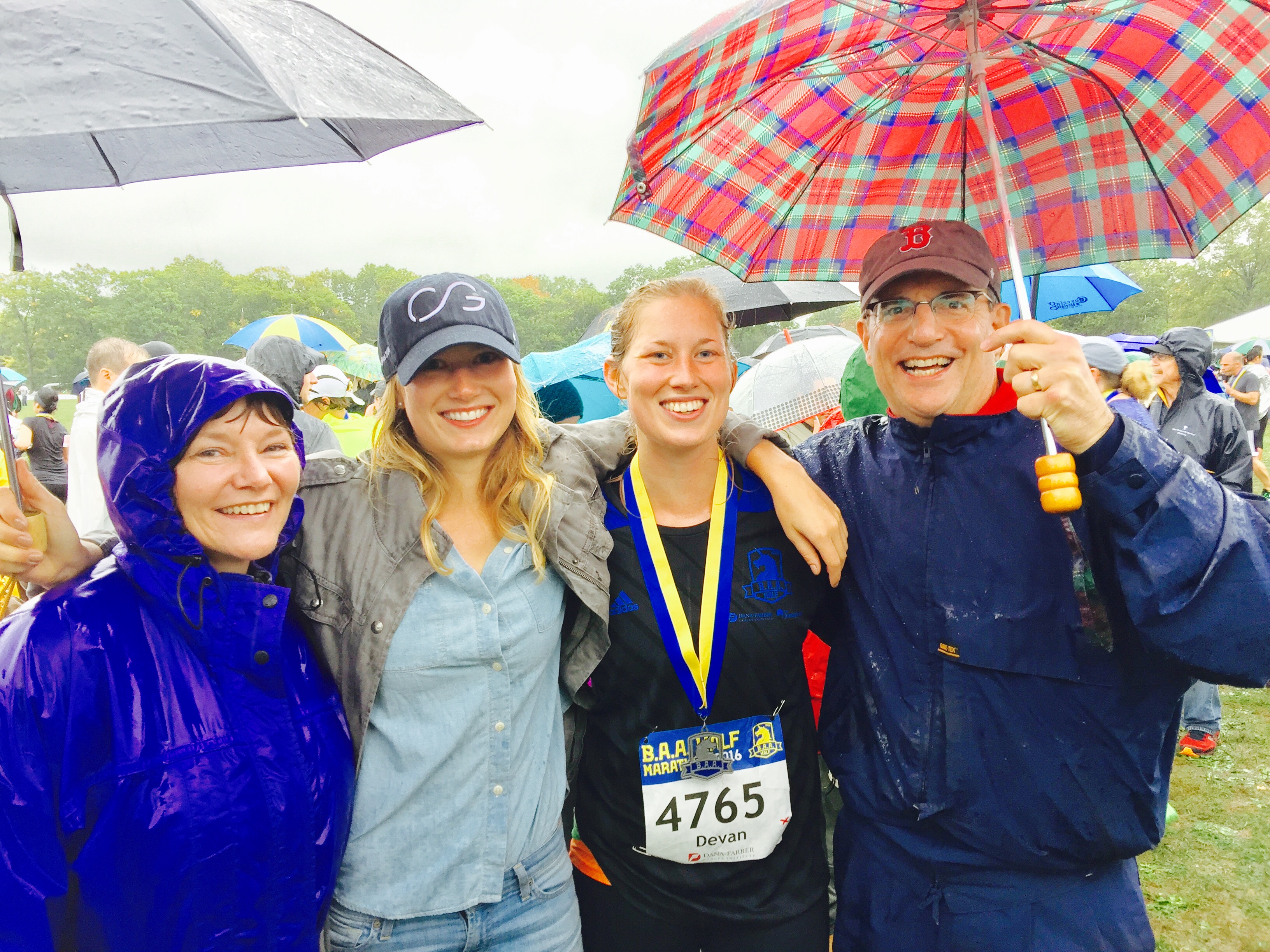 Runner with three family members in the rain