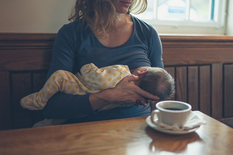 Breastfeeding woman in cafe