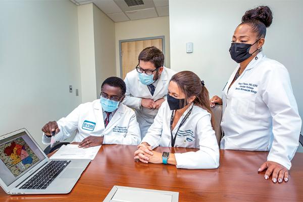 Group of researchers at computer.