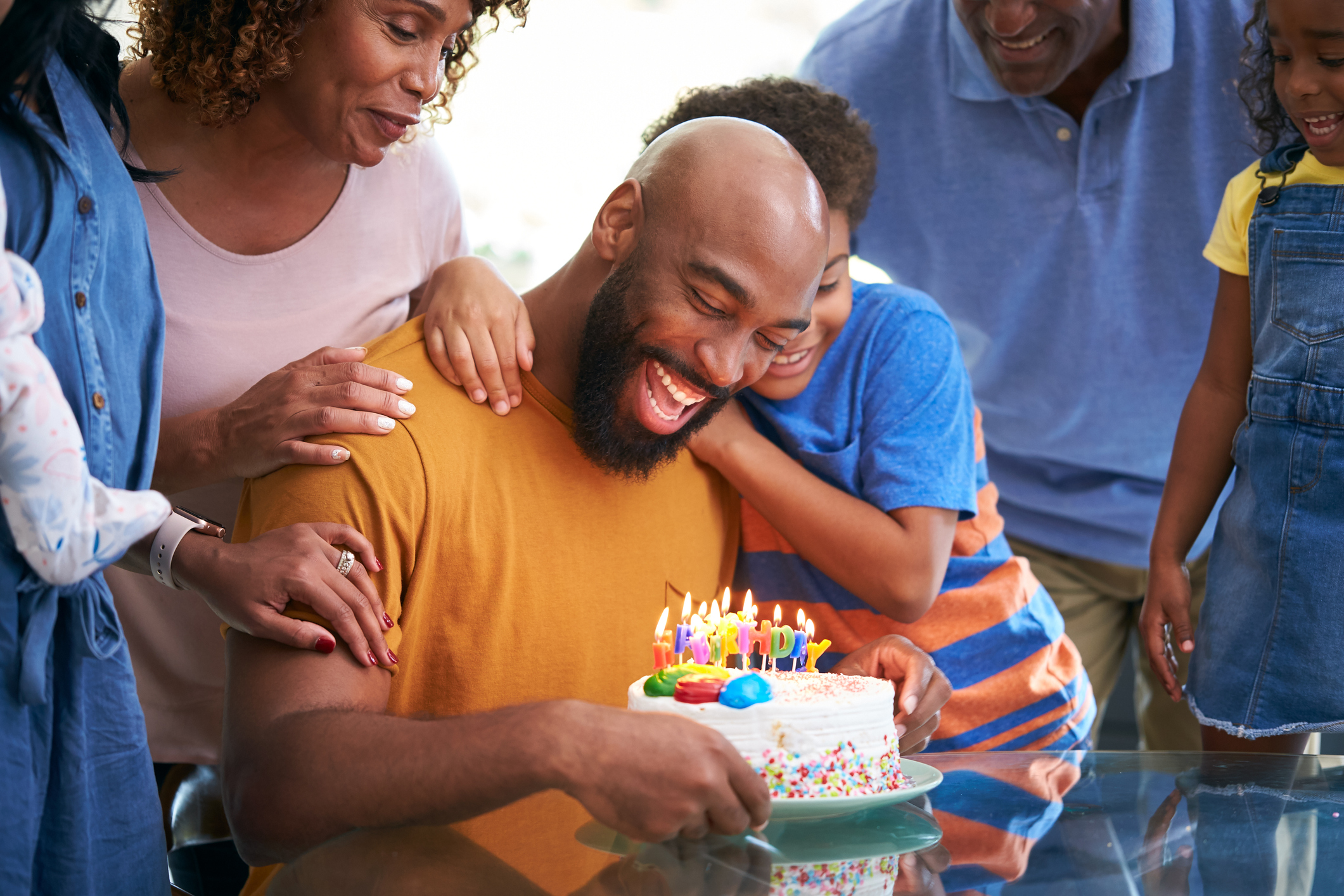 Black Man blowing out birthday candles
