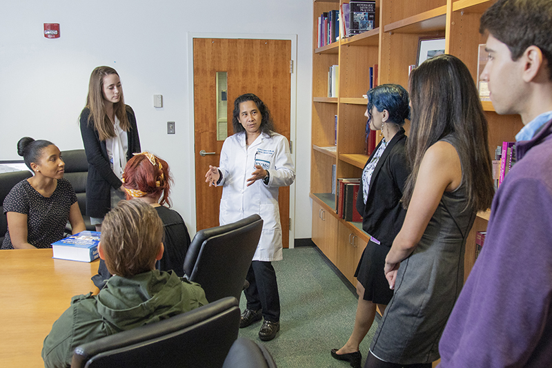students surrounding physician
