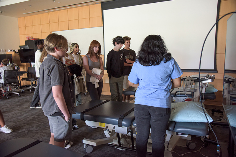 students gathered around ultrasound machine.