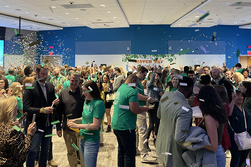 students throwing confetti in the air