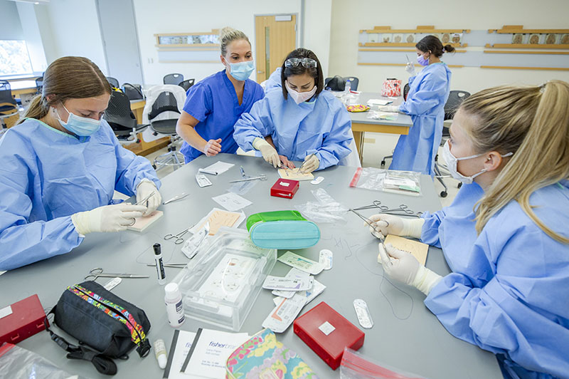 surgical assisting students practice suture skills