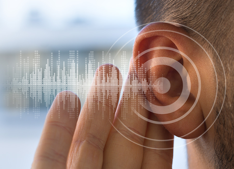 Close-up of a man holding his hand near his ear with graphics of sound waves overlaid
