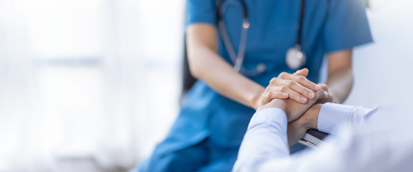 Cropped shot of a female nurse hold her senior patient's hand.