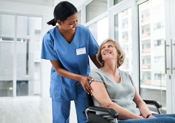 Shot of a young nurse caring for a senior woman in a wheelchair