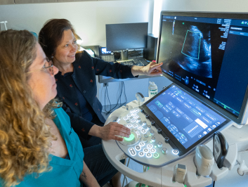 Dr. Sinkovskaya pointing at an ultrasound machine