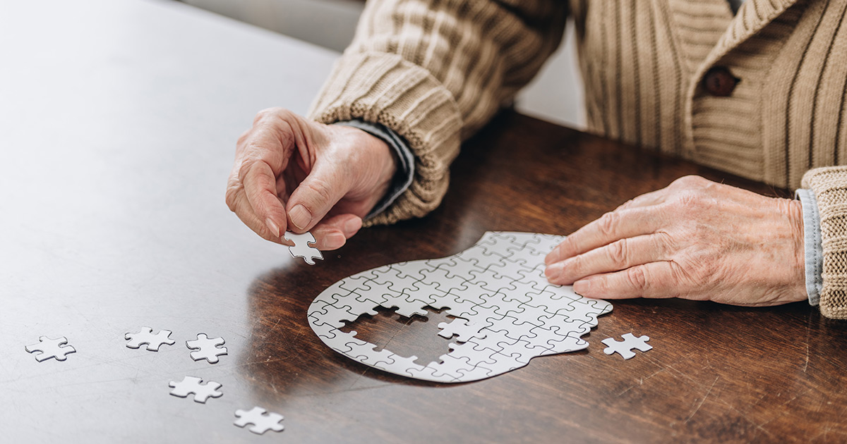 Older Gentleman putting down puzzle pieces