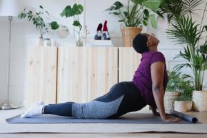 African American woman doing cobra yoga pose