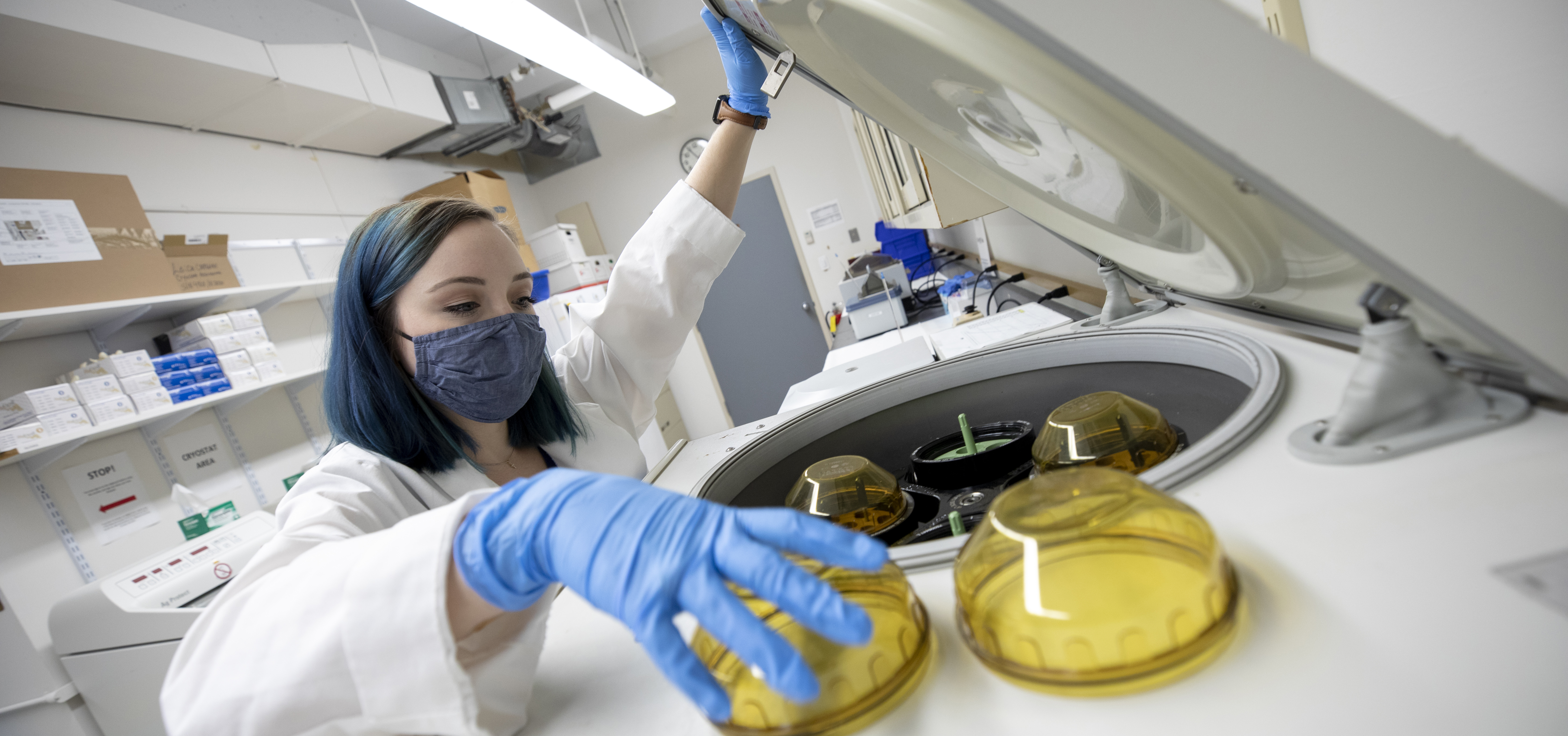 Woman putting items in lab equipment