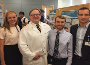 Musto and three researchers at Research Day