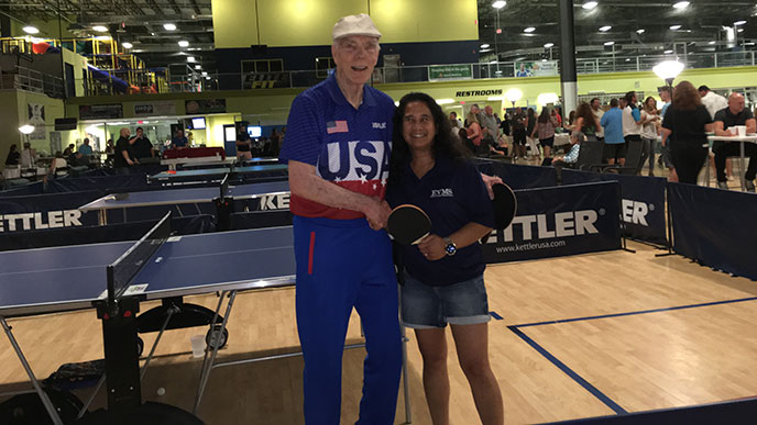 Table tennis hall-of-fame inductee Dean Johnson and Dr. Marissa Galicia-Castillo smile for a photo at the Ping Pong for Charity tournament, held to improve mental health and brain fitness. EVMS Glennan Center is proud to be one of the charities of the tournament.