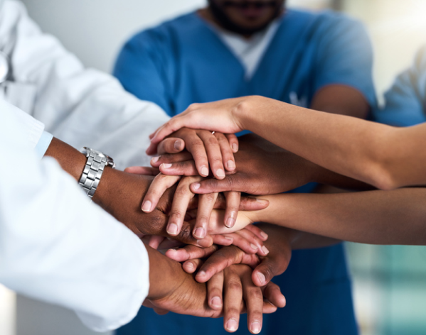 Medical team with their hands in the middle in a circle