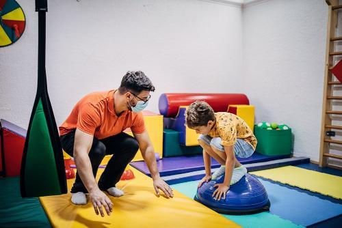 Man and little boy on colorful mat