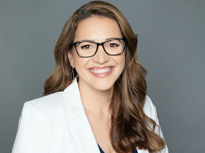 Jennifer Styron, PhD wearing a white lab coat and glasses. Updated 12-15-2020
