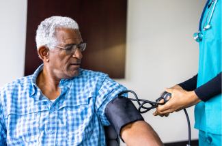 Male patient getting his blood pressure taken.