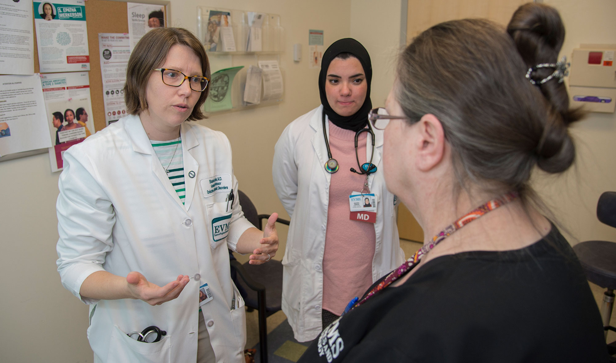 A physician and resident work with a patient at the Strelitz Diabetes Center.