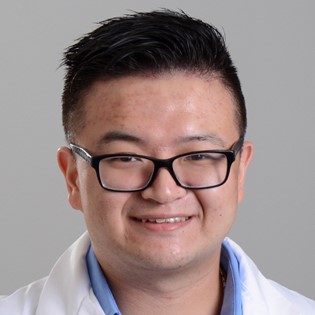 Headshot photo of Dr. Cheng smiling for a photo.