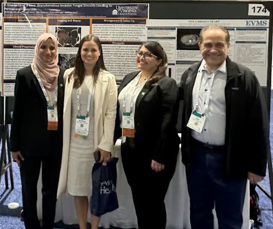 Drs. Ayeman Basith and Sarah Al Allawi (PGY3’s) stand next to their posters with Drs. Sami Tahhan (EVMS) and McKenna Johnson (VACCHS)