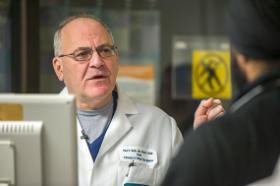 Dr. Paul Marik, Pulmonary Disease and Critical Care Medicine Chief, talks with a fellow.