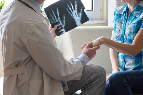 headless doctor holds hand of headless female patient