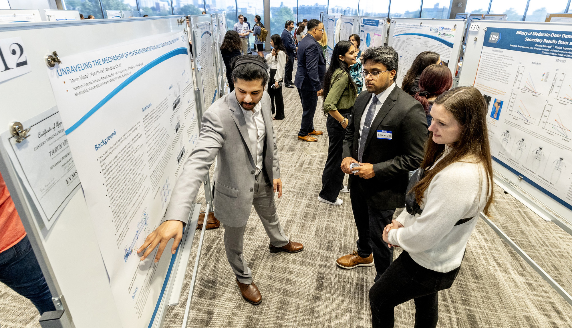 Diverse group of trainees presenting their research during EVMS Research Day 2023
