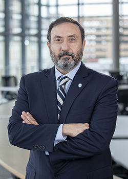 Dr. Alfred Z. Abuhamad standing in a modern building looking confident