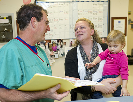 A Clinical Research Unit physician talks with a parent.