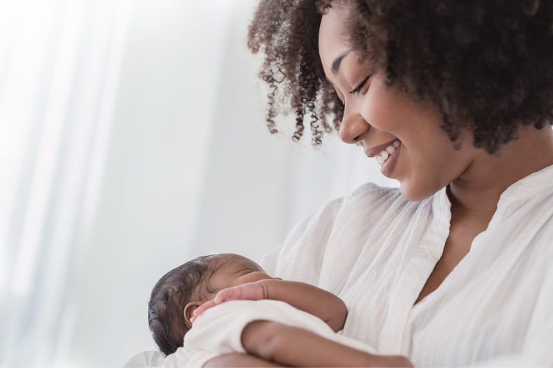 African American woman holding infant