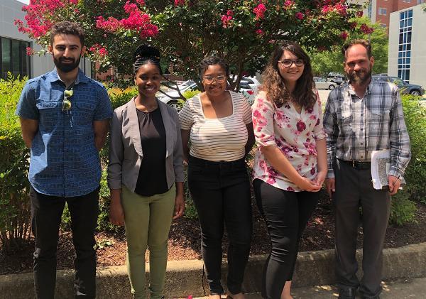 Members of the Behavioral Epidemiology and Pharmacology Laboratory pose for a photo under a tree outside Williams Hall.