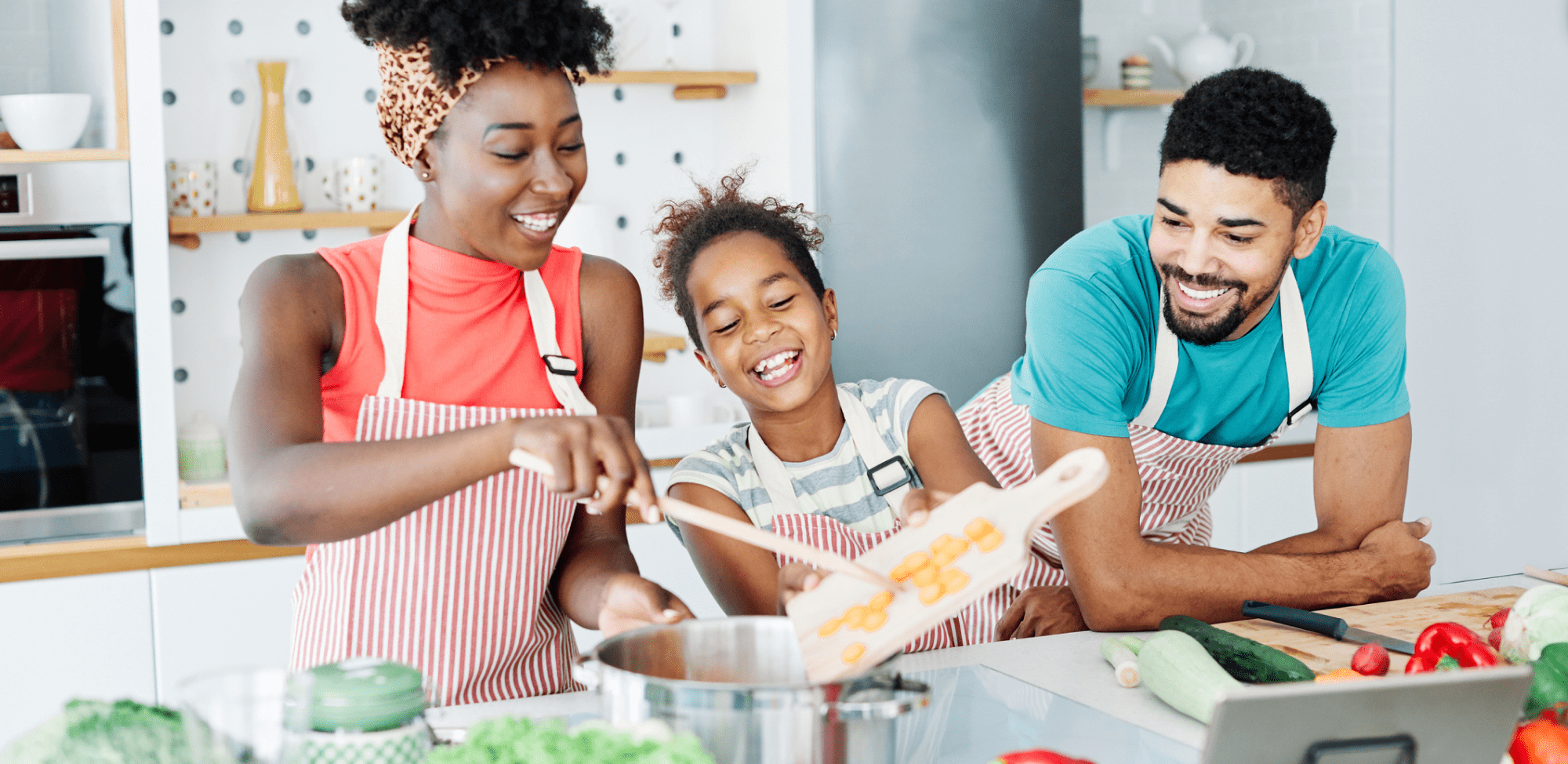 Family preparing a healthy meal and having fun in the kitchen at home