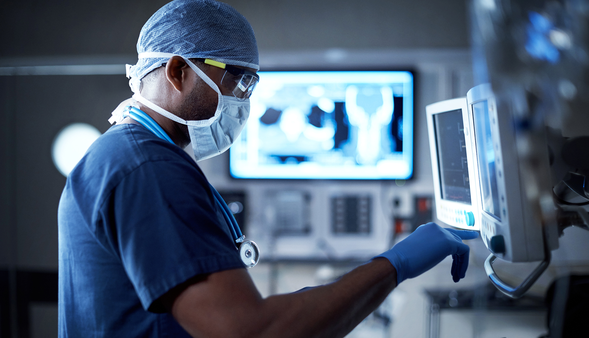 A radiologist looks closely at a medical image.