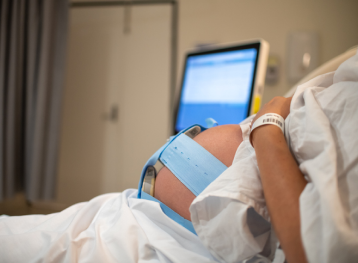 Monitoring the heart rate of a baby during the early stages of labor.