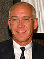 Lawrence B. Colen, MD, smiles at camera wearing a suit and glasses
