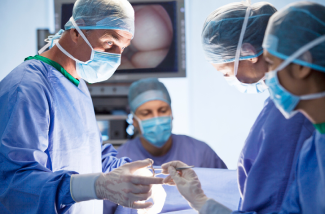 Surgeons operating using surgical equipment