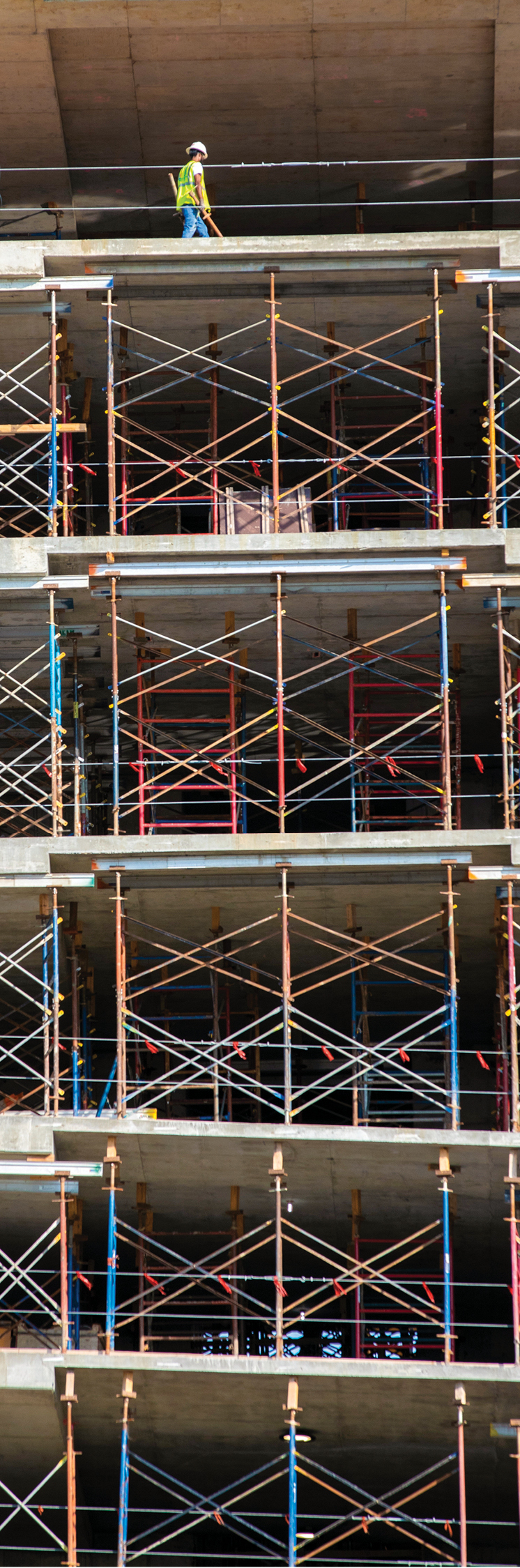 As concrete continues to cure, scaffolding supports several decks of flooring.