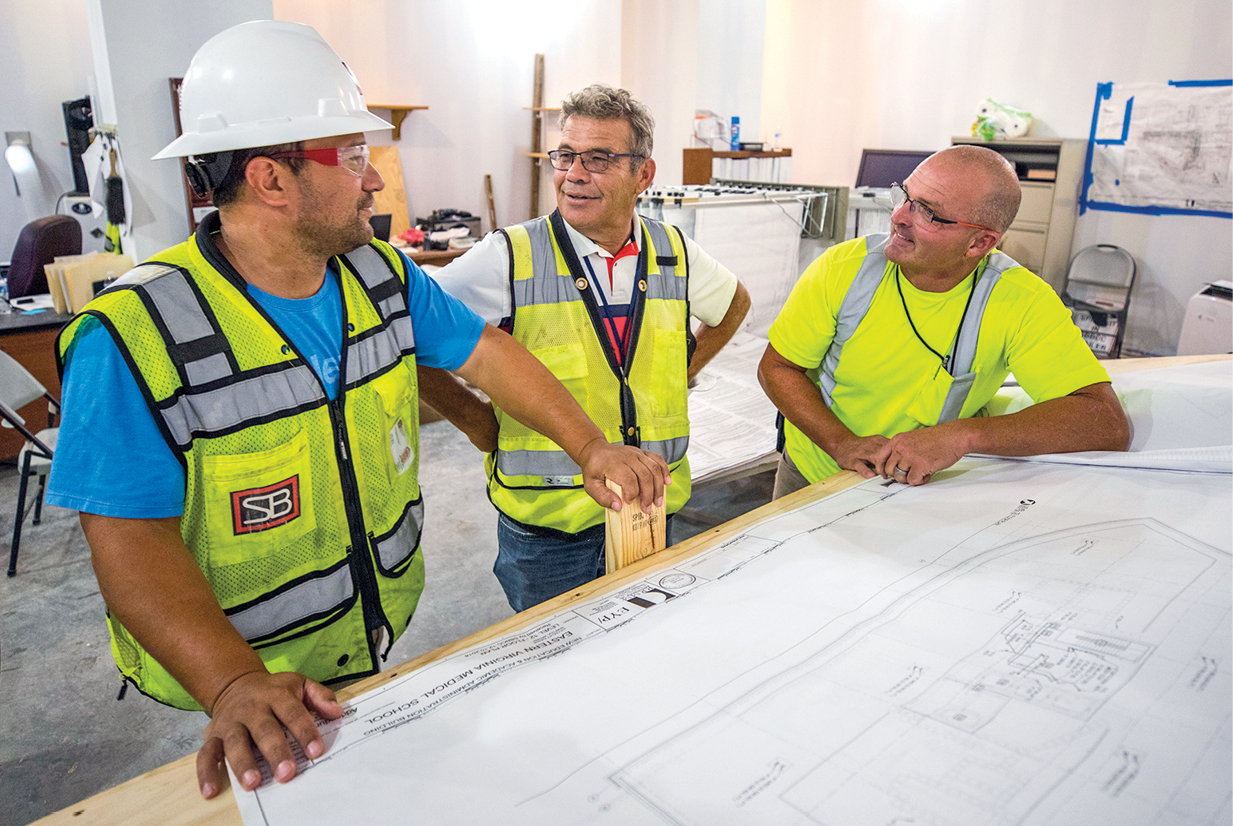 Greg Vuyovich, Project Manager for EVMS, center, speaks with Carleton Bitgood, S.B. Ballard EVMS Project Manager, left, and Billy Hubbard, S.B. Ballard EVMS Superintendent.