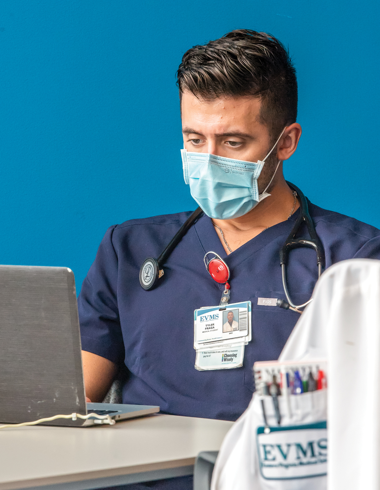 Medical student, Tyler Fraga, wears a face mask while studying with his laptop computer at Waitzer Hall.