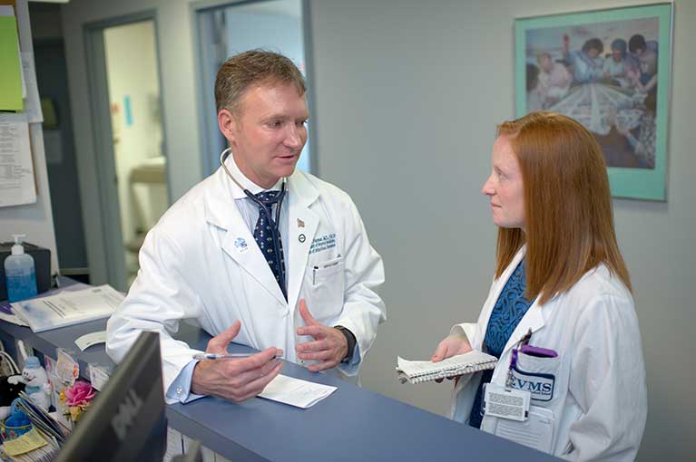 Dr. Flenner speaks with a student